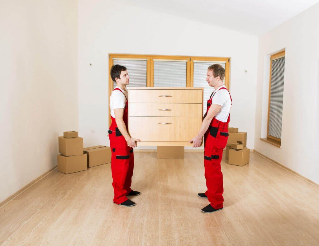 Two boys shifting a draw box in home at Hurst, TX