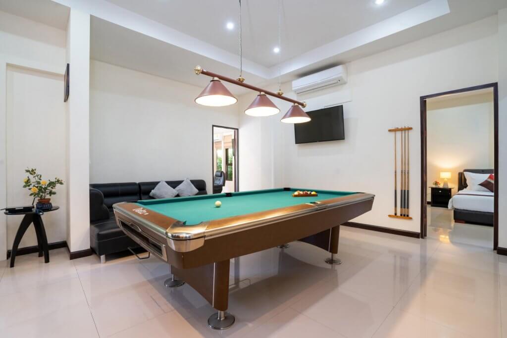 Interior design of modern house, home, villa feature pool table, shelve, sofa and television in living room
