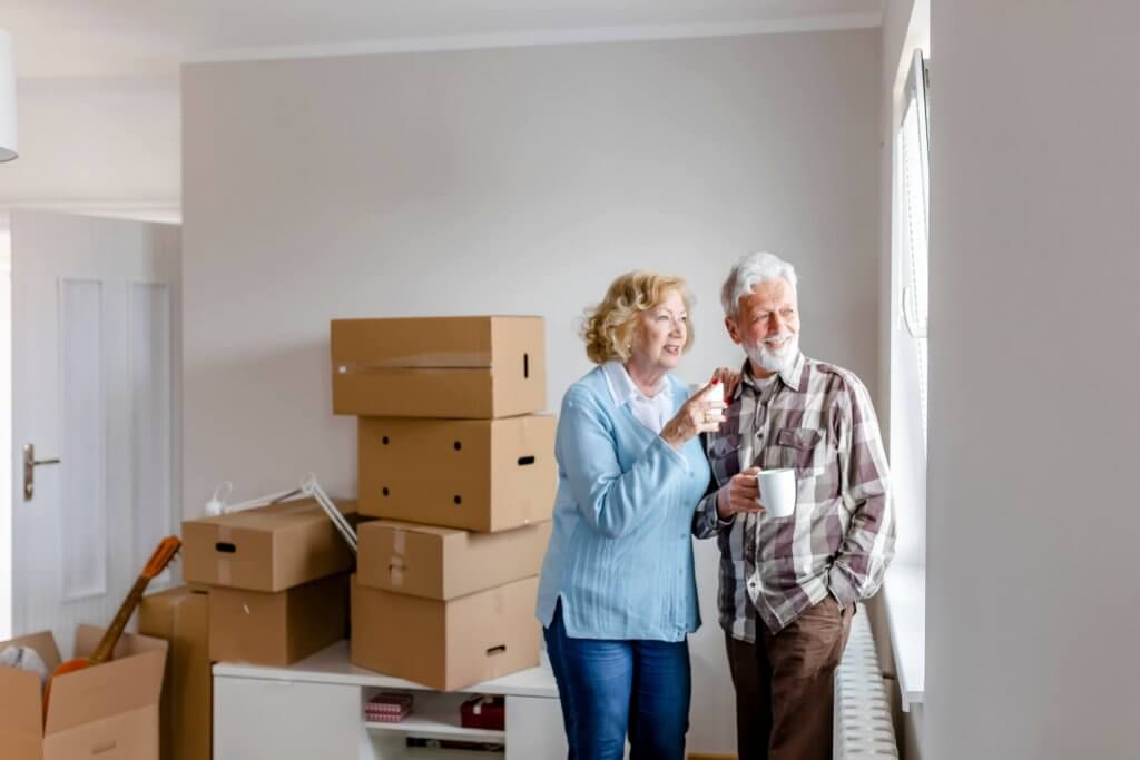 Senior Couple at Moving Day Looking Through the Window