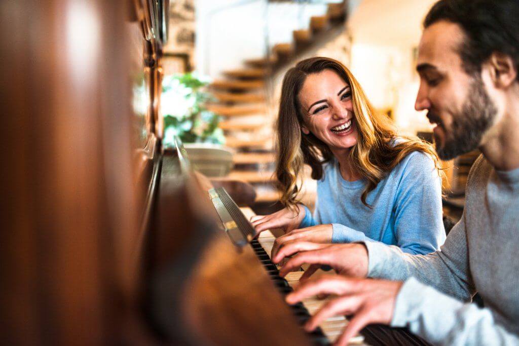 french couple playing the piano in a parisen house