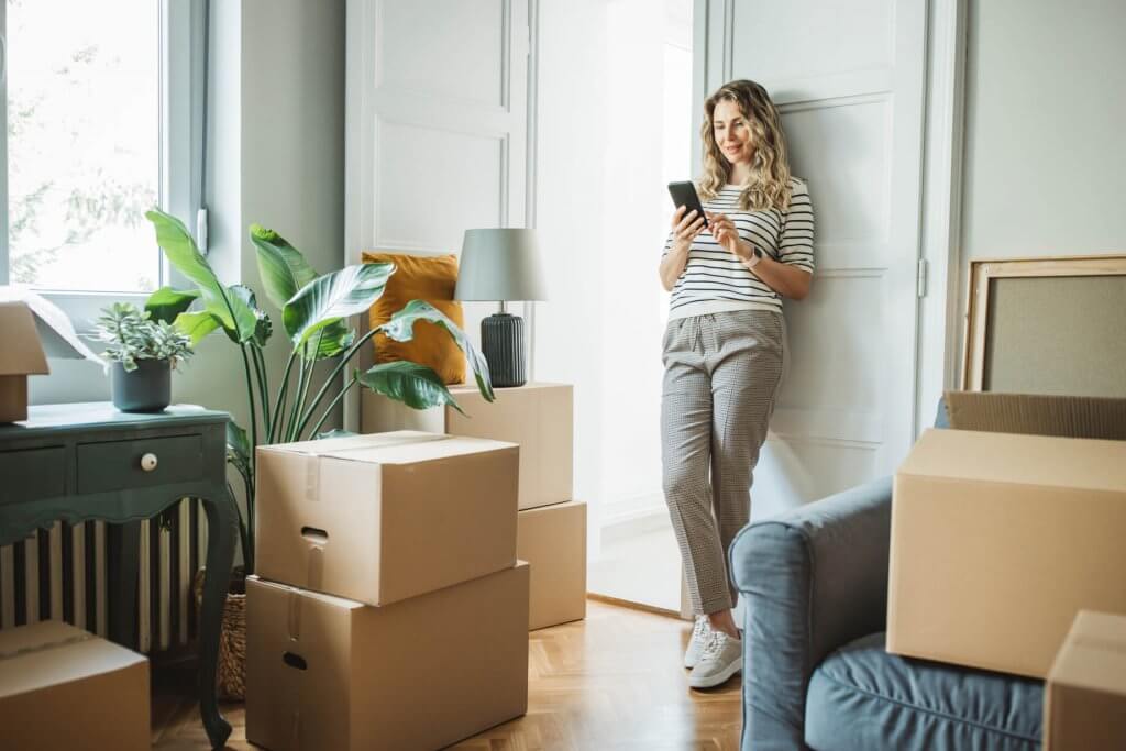 Woman with Moving Boxes in New Home