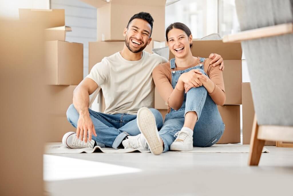 Young couple sitting on the floor while moving house