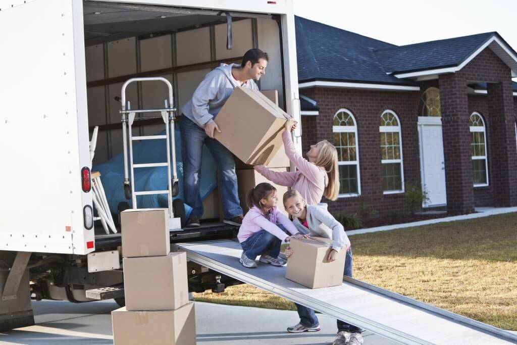 Family moving house, unloading truck