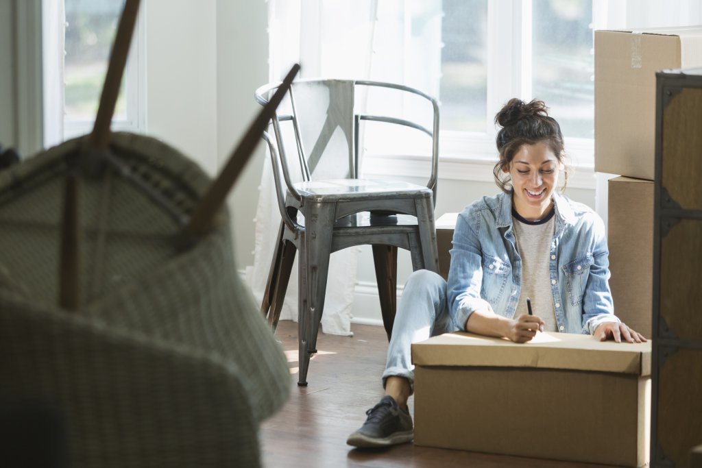 Woman moving, writing checklist