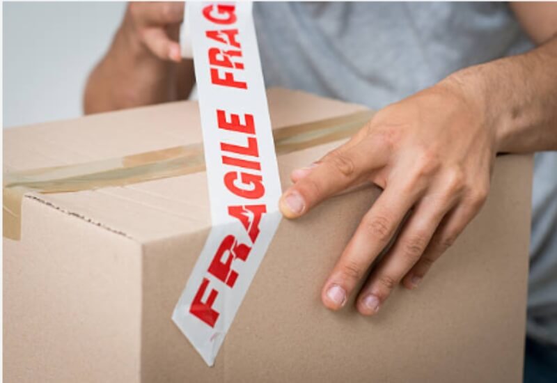 The man packing the fragile box